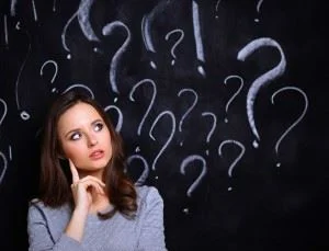 Young girl with question marks around her