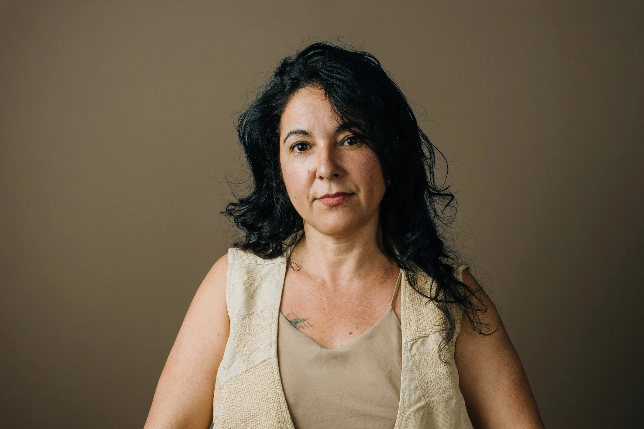 Portrait of middle aged woman in studio with brown background