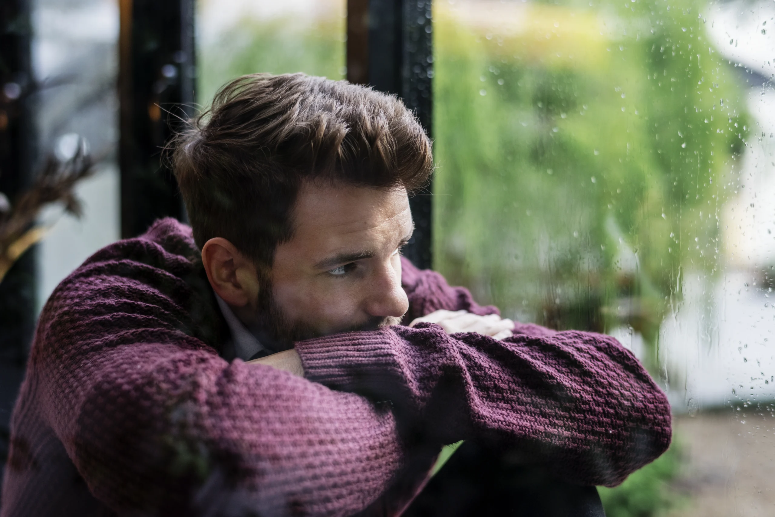 drug addicted man looking out the window