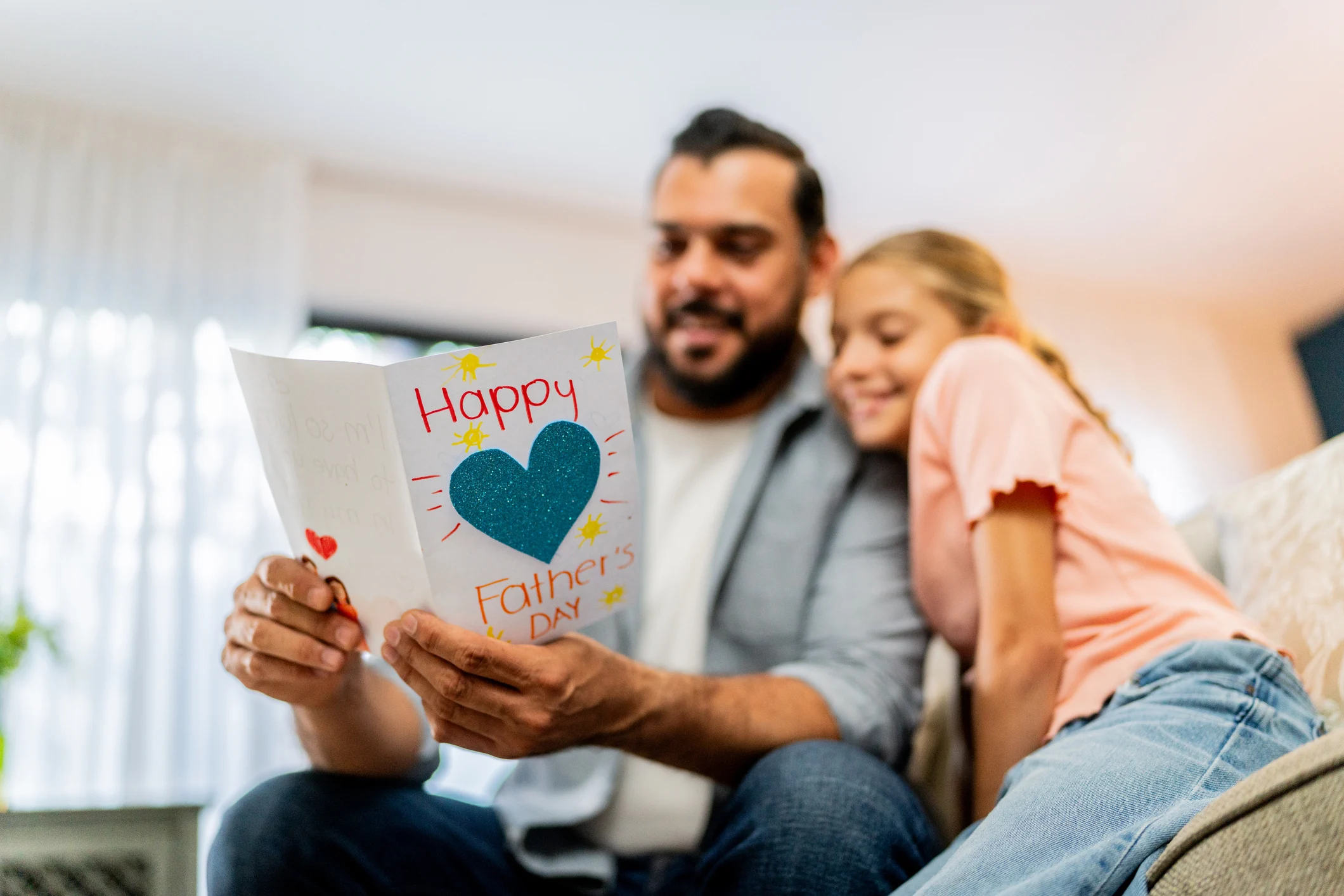 Close-up of father holding a father's day gift at home