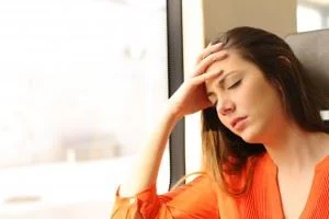 Female passenger feeling dizzy on a train