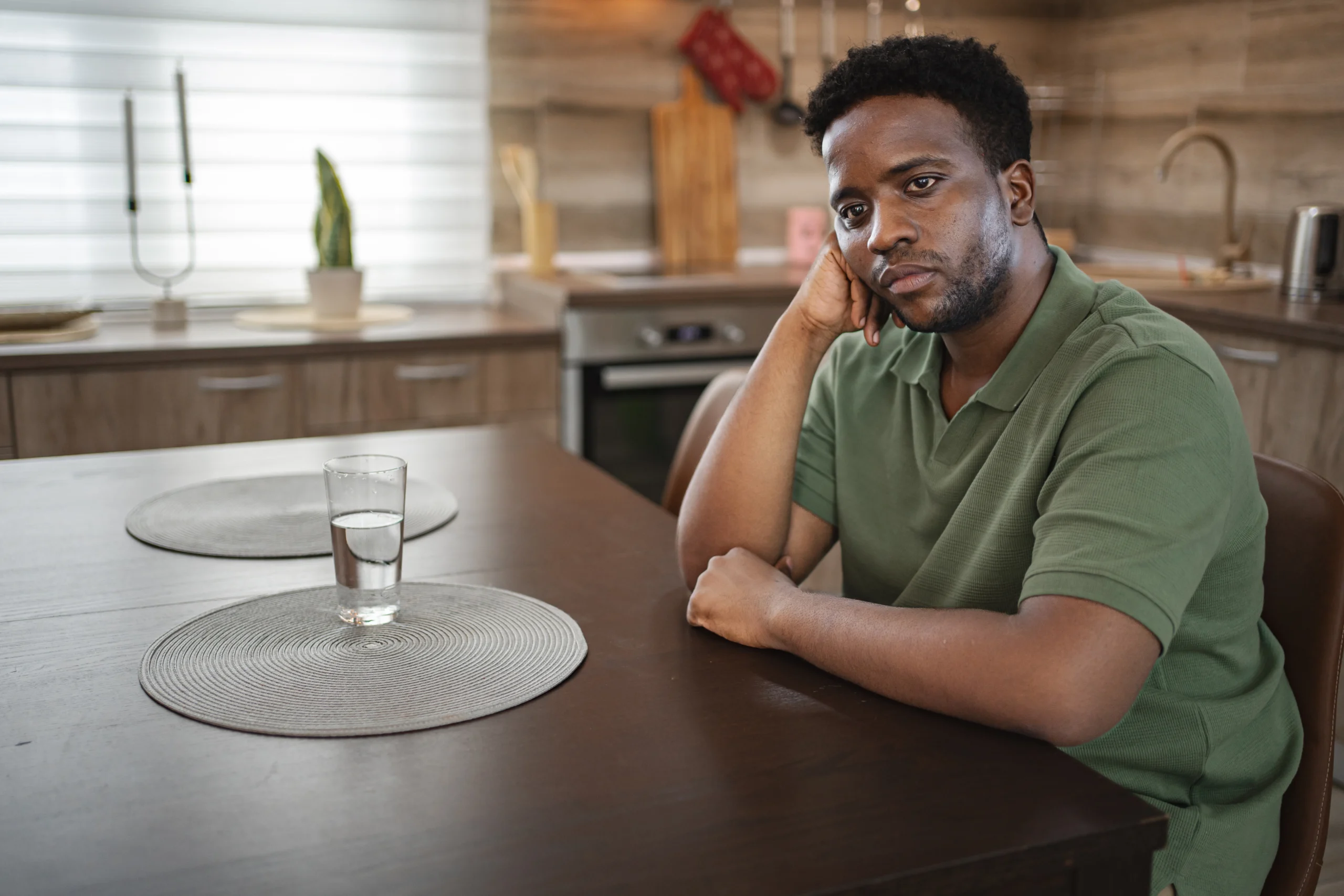 Distraught man sitting at home