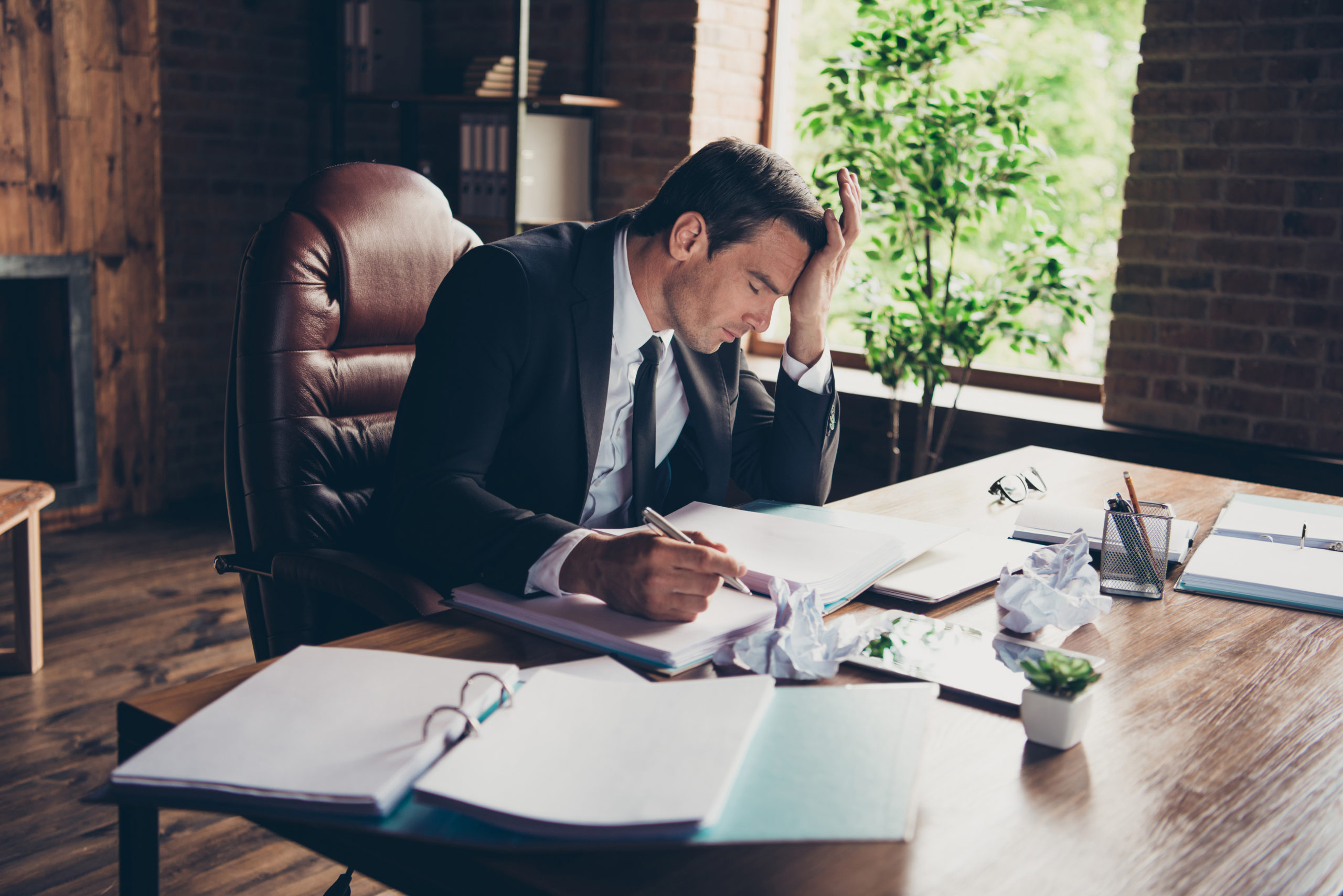 Profile side view portrait of elegant classy handsome sad man business shark ceo boss chief attorney lawyer writing article fail failure at work place station table desktop