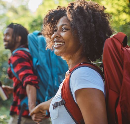 African American couple on a hike holding hands and smiling