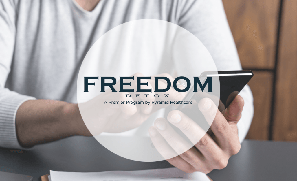 Freedom Detox a man on his phone