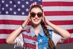Portrait of smiling stylish female in USA get-up