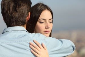 Sad woman hugging her boyfriend