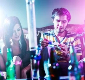 man and woman at party doing drugs