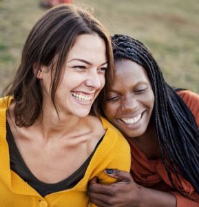 Multiracial friends smiling and enjoying each others company