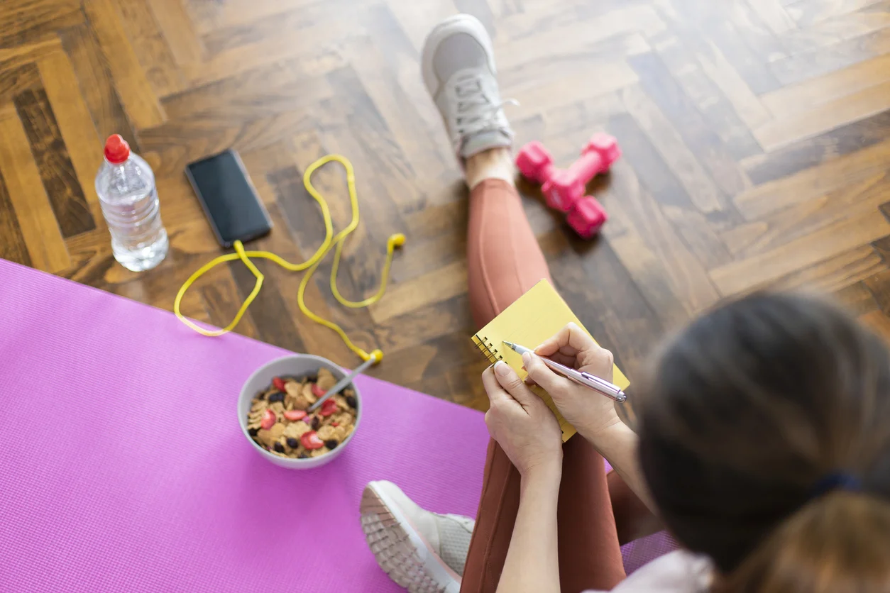 A young woman journaling after a workout