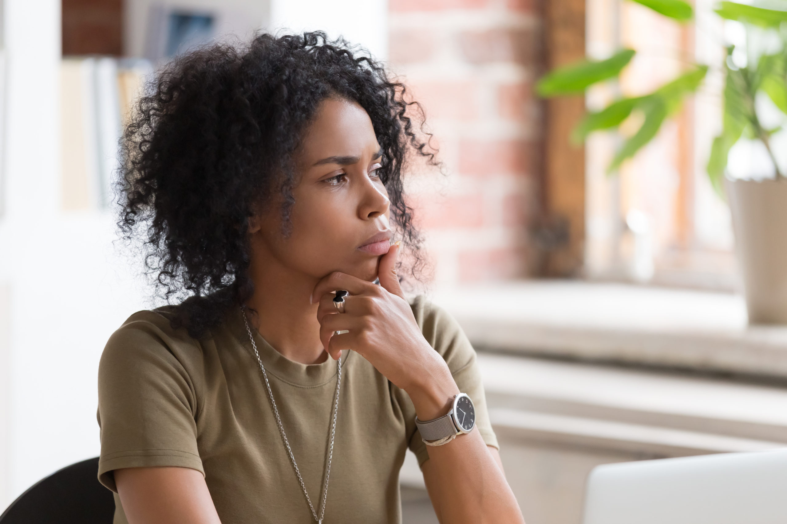 Thoughtful doubt African American businesswoman or student with hand under chin feeling uncertain, thinking about project or difficult task, manager pondering business strategy, planning, close up