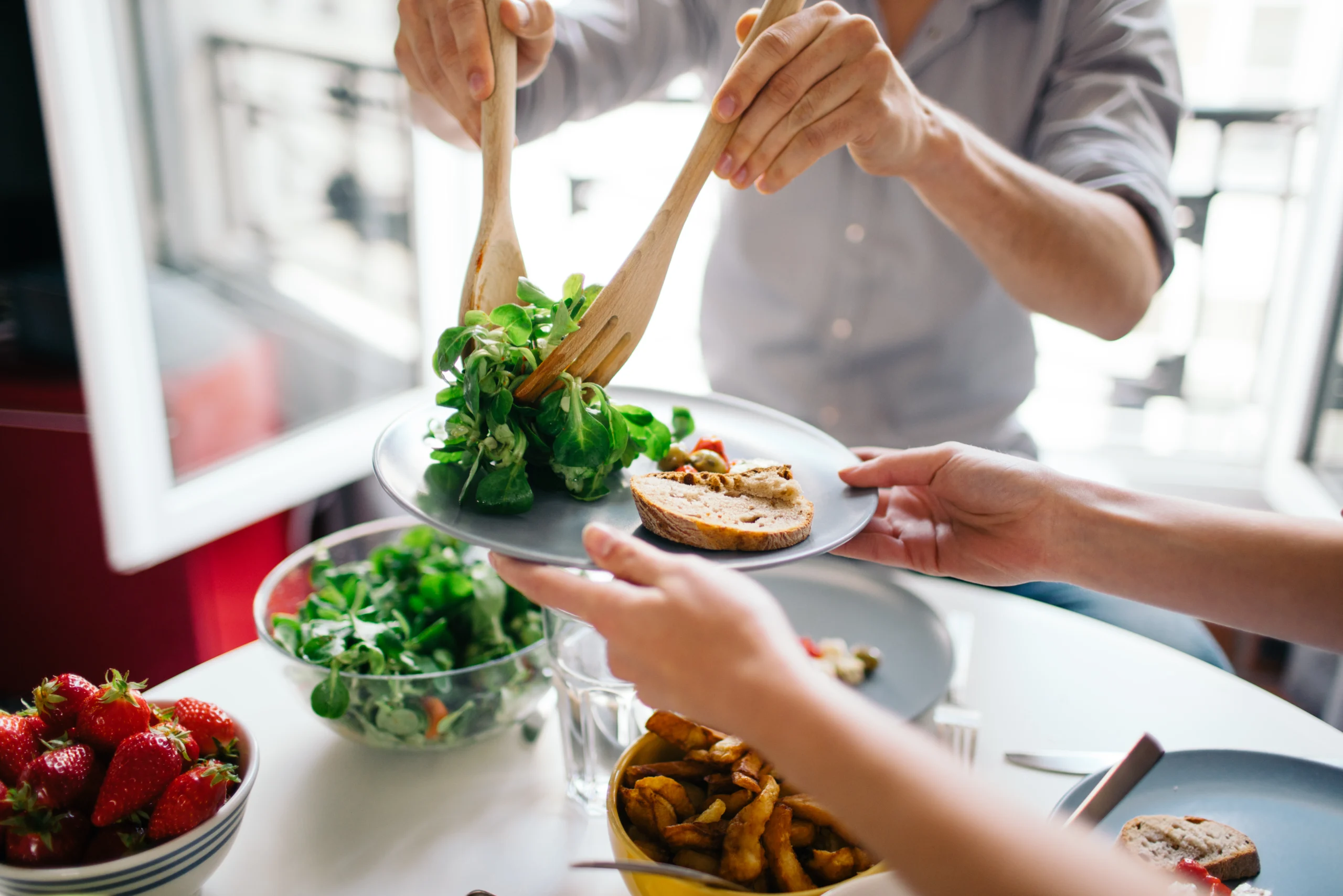A man scooping salad