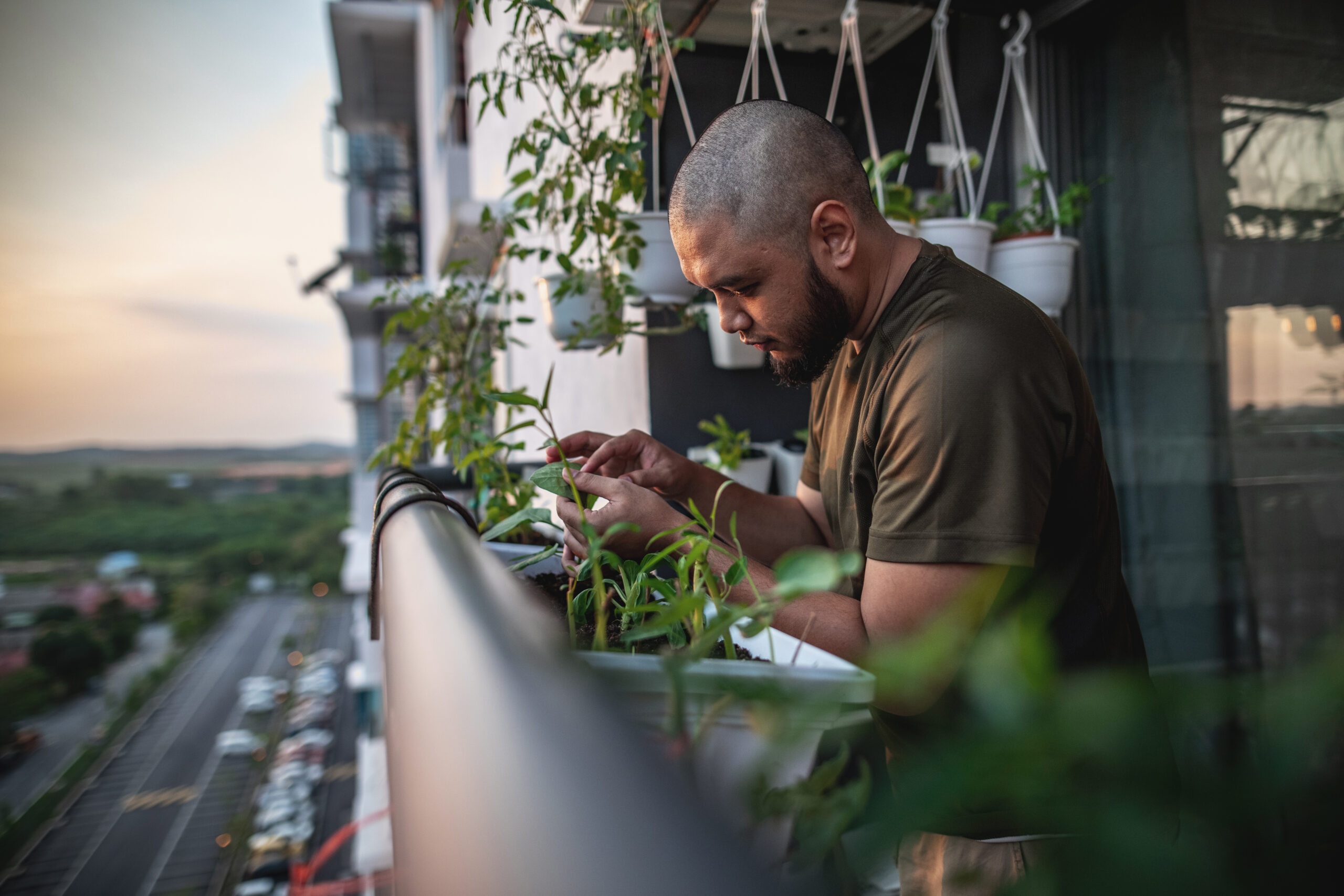 A man tending to his plants on his porch