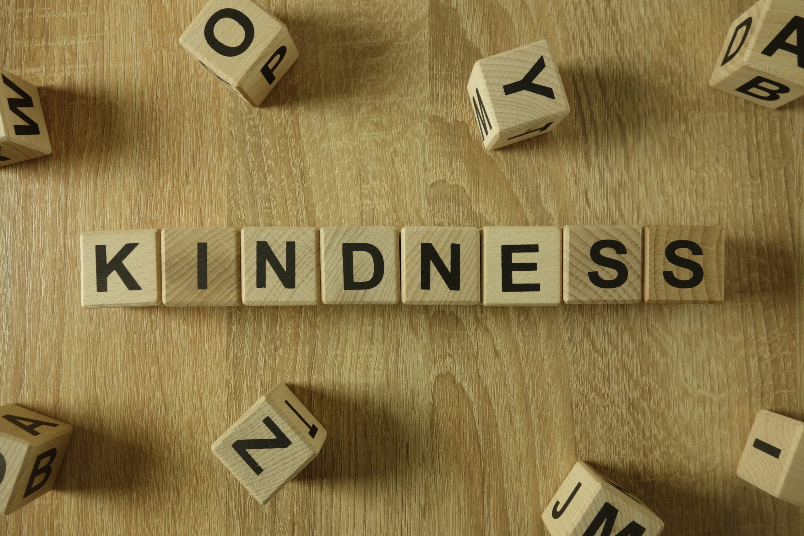 Kindness word from wooden blocks on desk