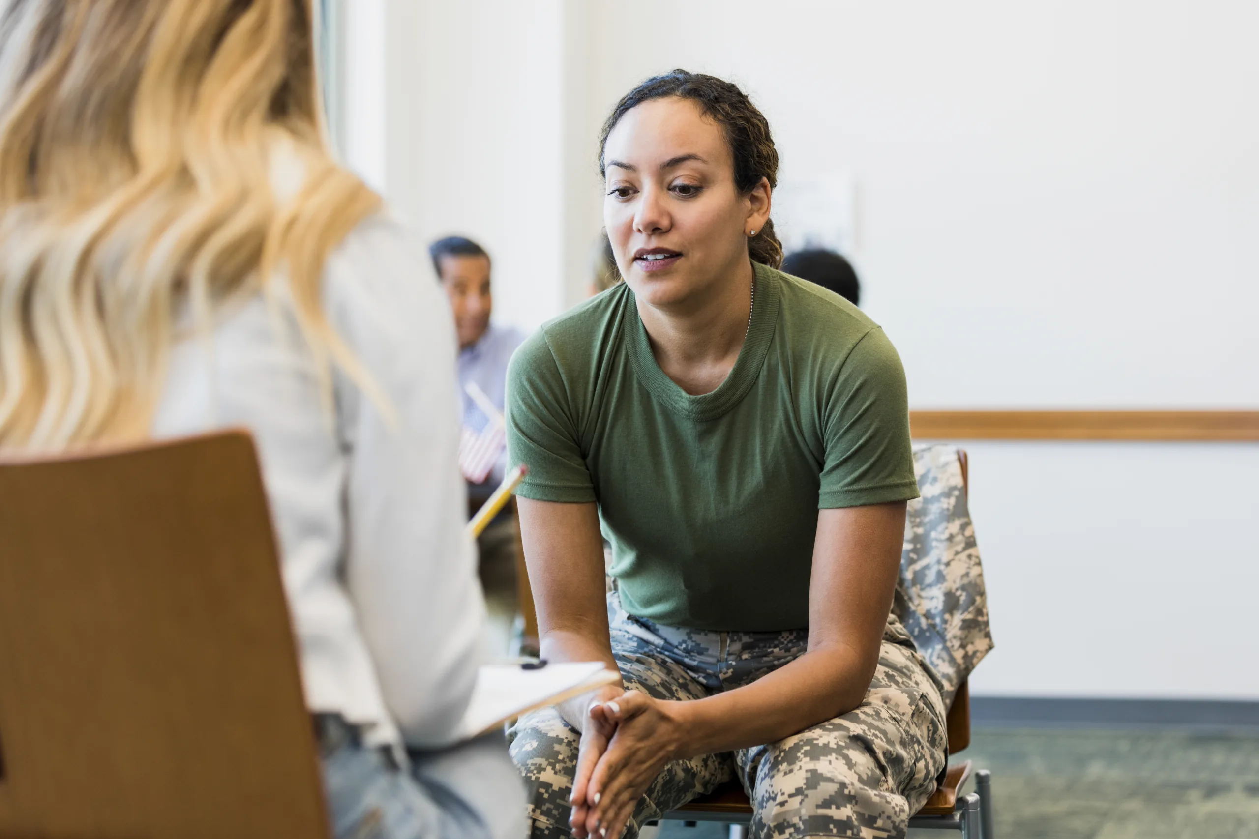 While at a counseling center for soldiers, a vulnerable female soldier discusses issues with a counselor.