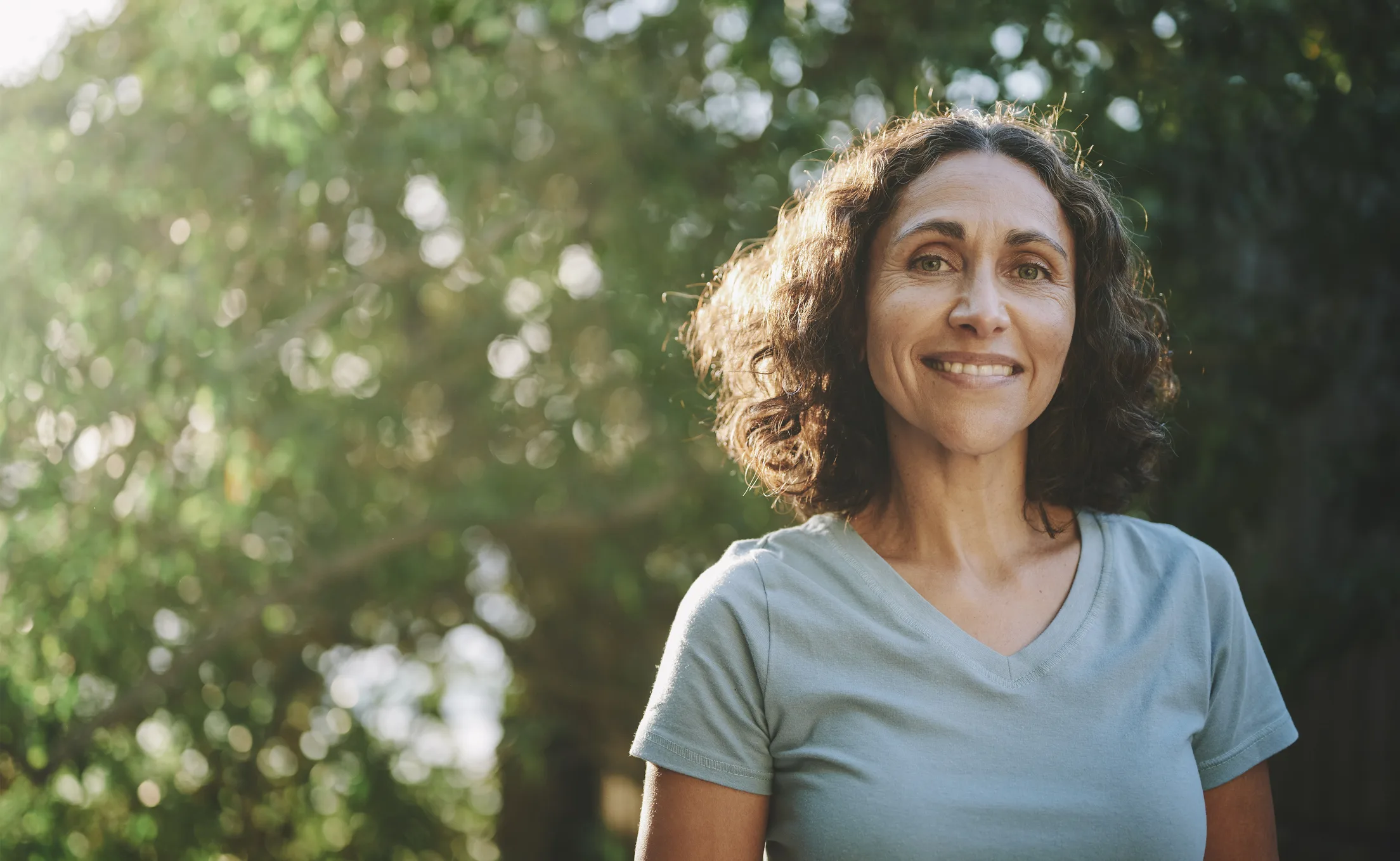 Woman smiling and feeling healthier after quitting drinking