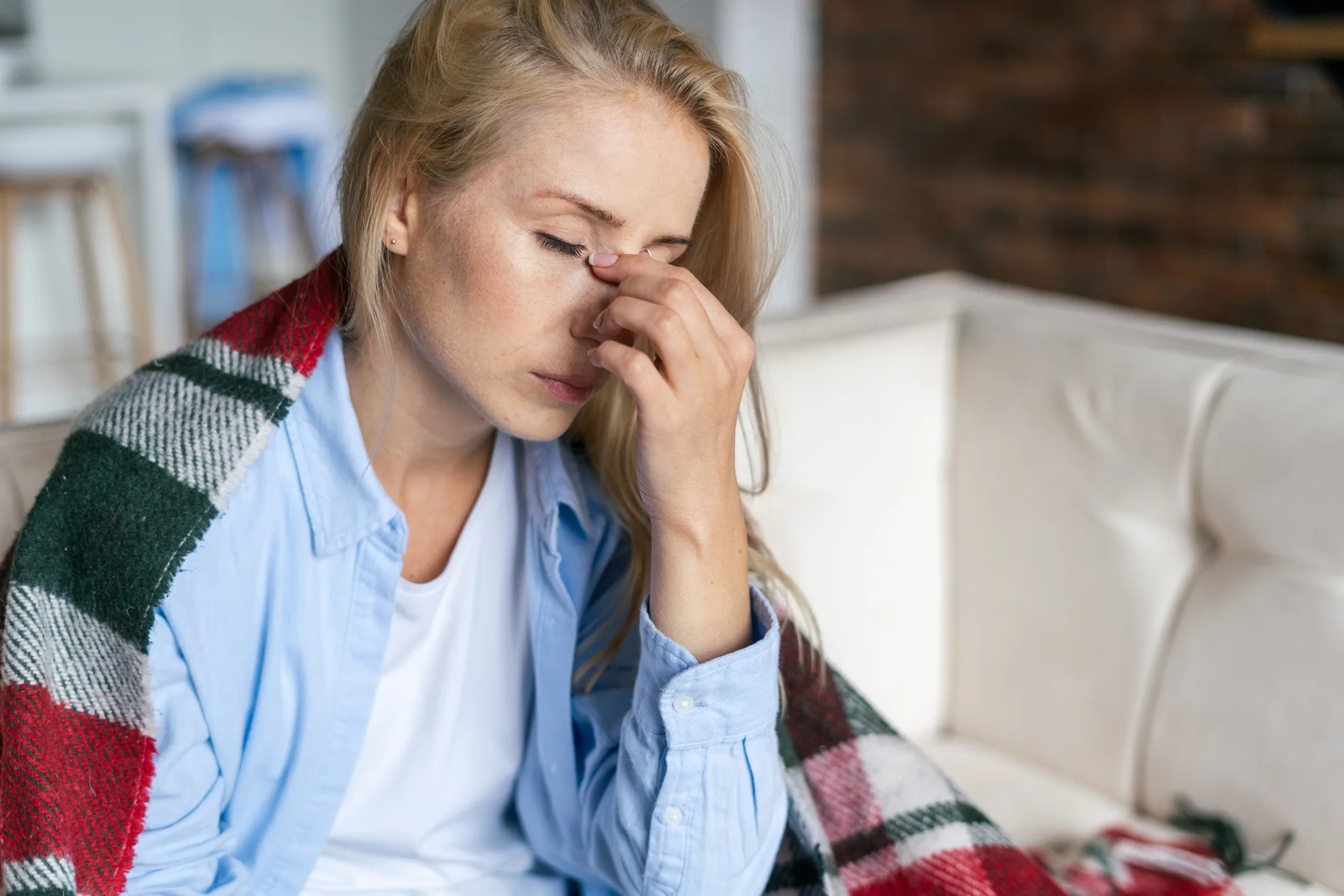 Woman holding face in her hand dealing with fatigue as a result of sobriety