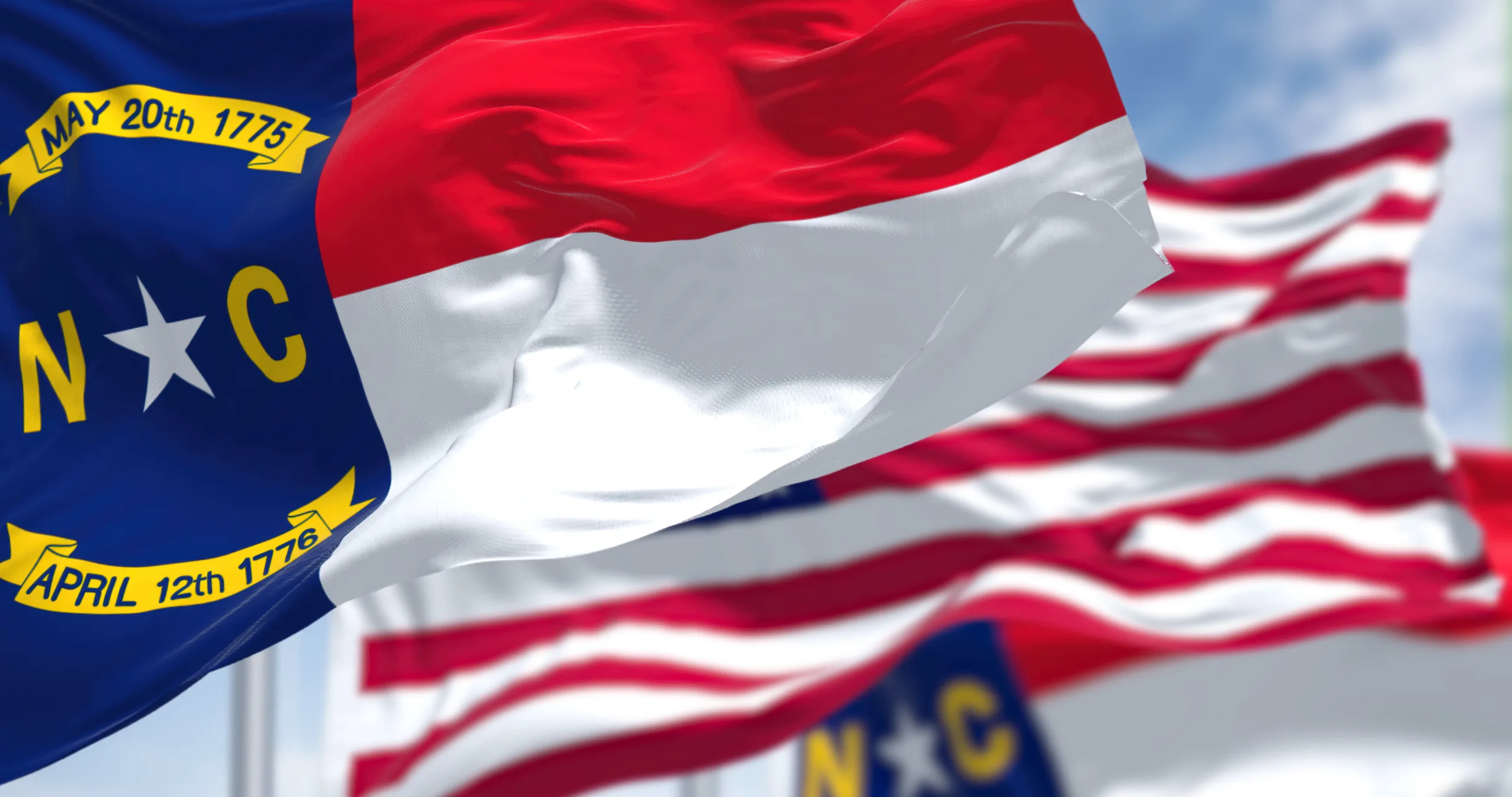 North Carolina flag with United States flag behind it