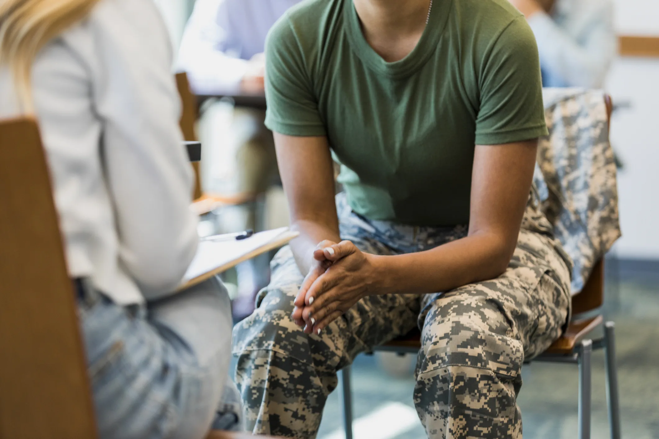 close up of veteran sitting across from provider receiving treatment for OCD related to deployment triggers