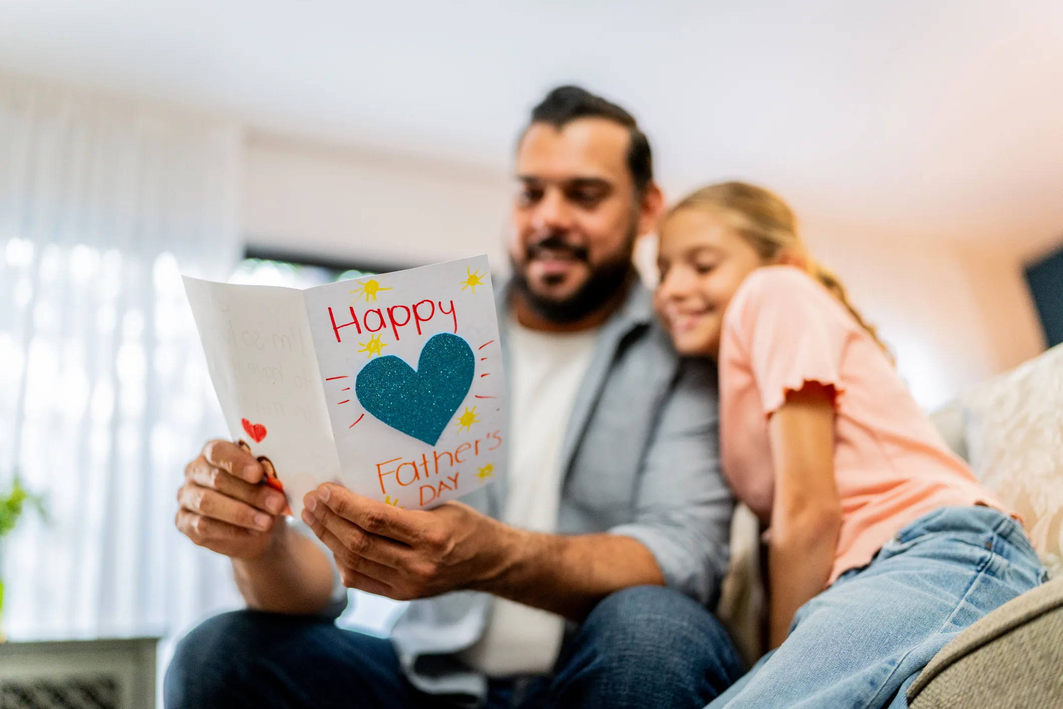 Close-up of father holding a father's day gift at home