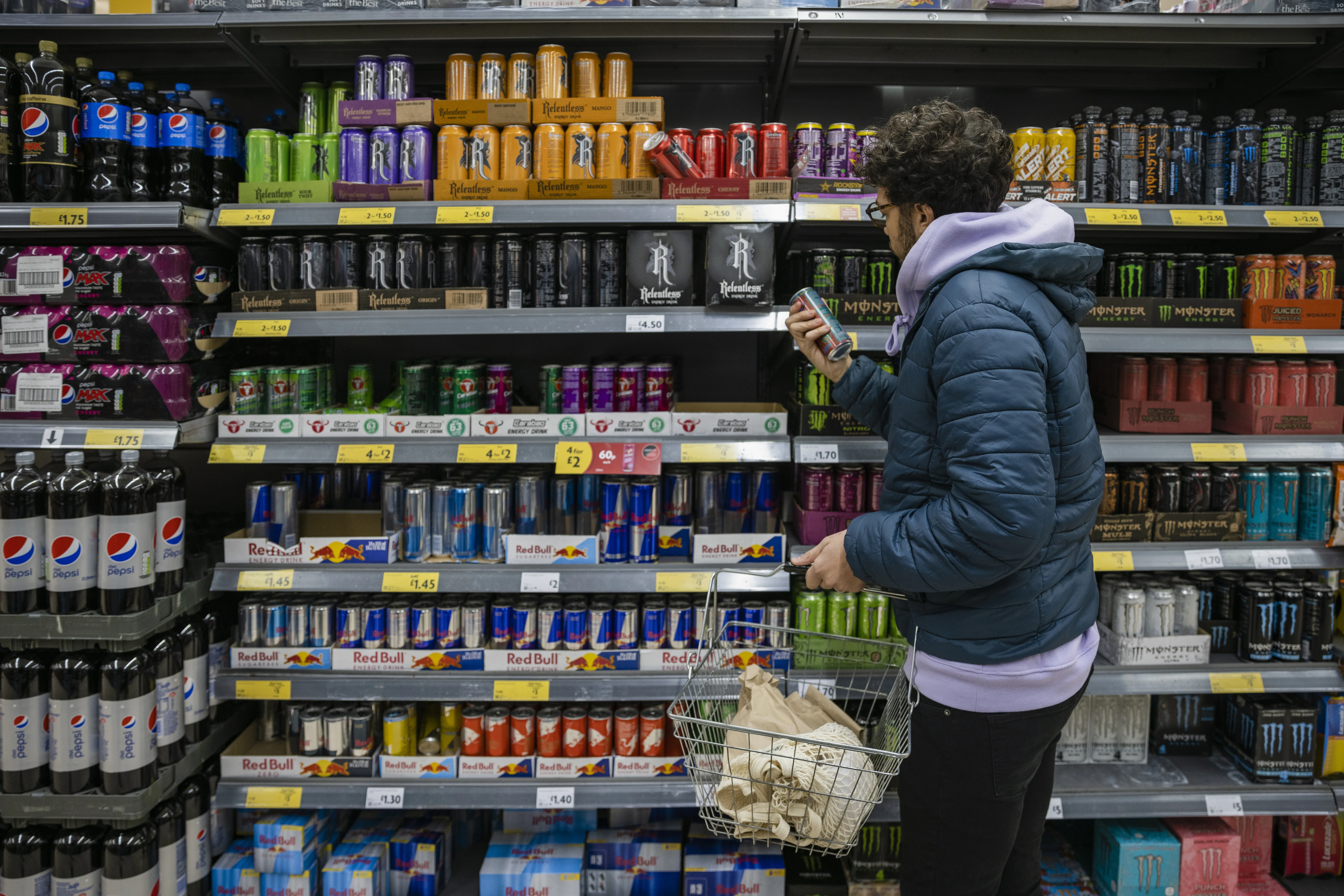 Man browsing energy drinks at supermarket looking for Feel Free drink